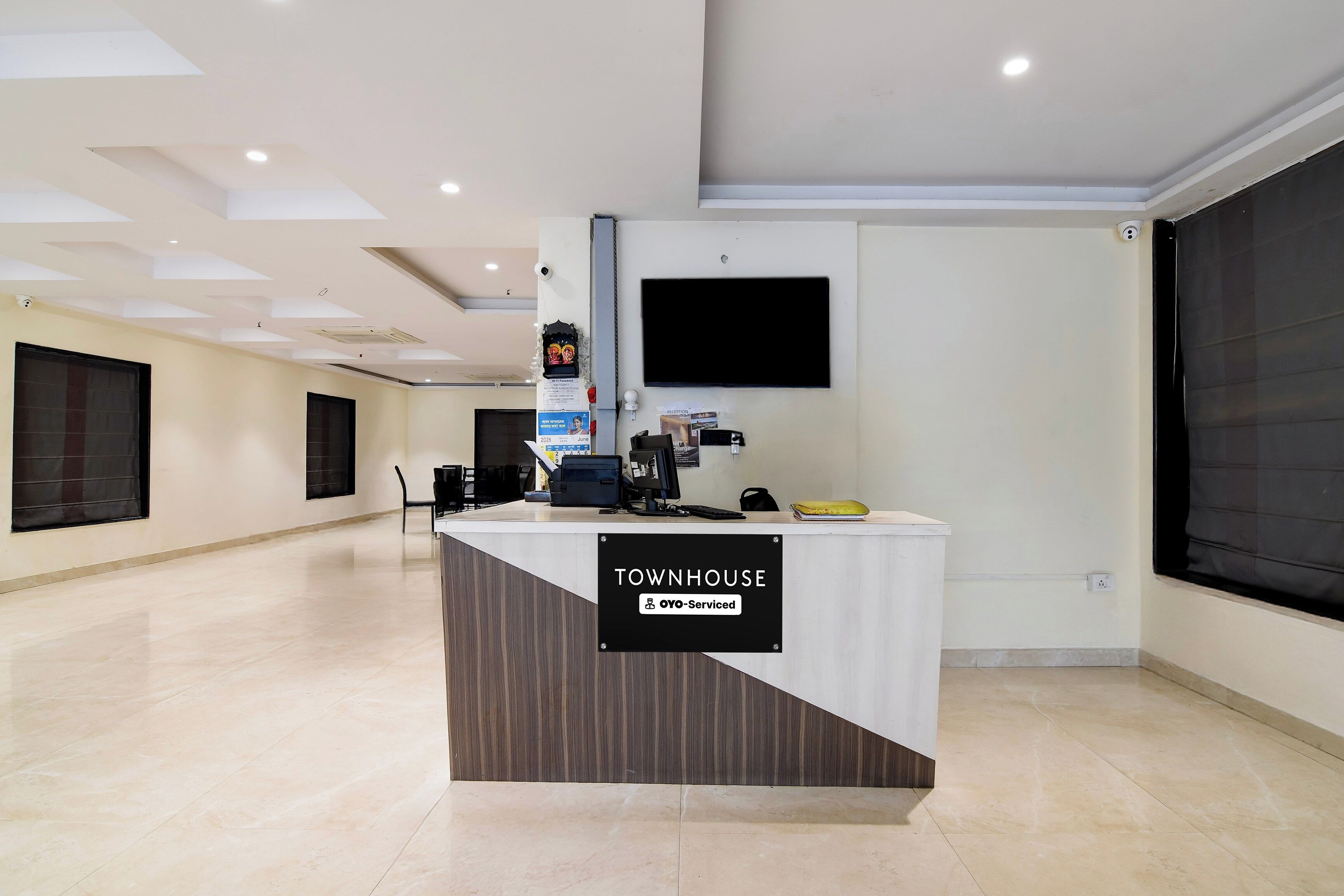 A reception desk labeled 'TOWNHOUSE' with a sign indicating 'OOO-Serviced.'