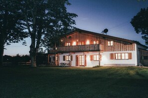 A two-story wooden building with a balcony, large windows, and a satellite dish. - Luna Mia Apartment 3 (Schwangau)