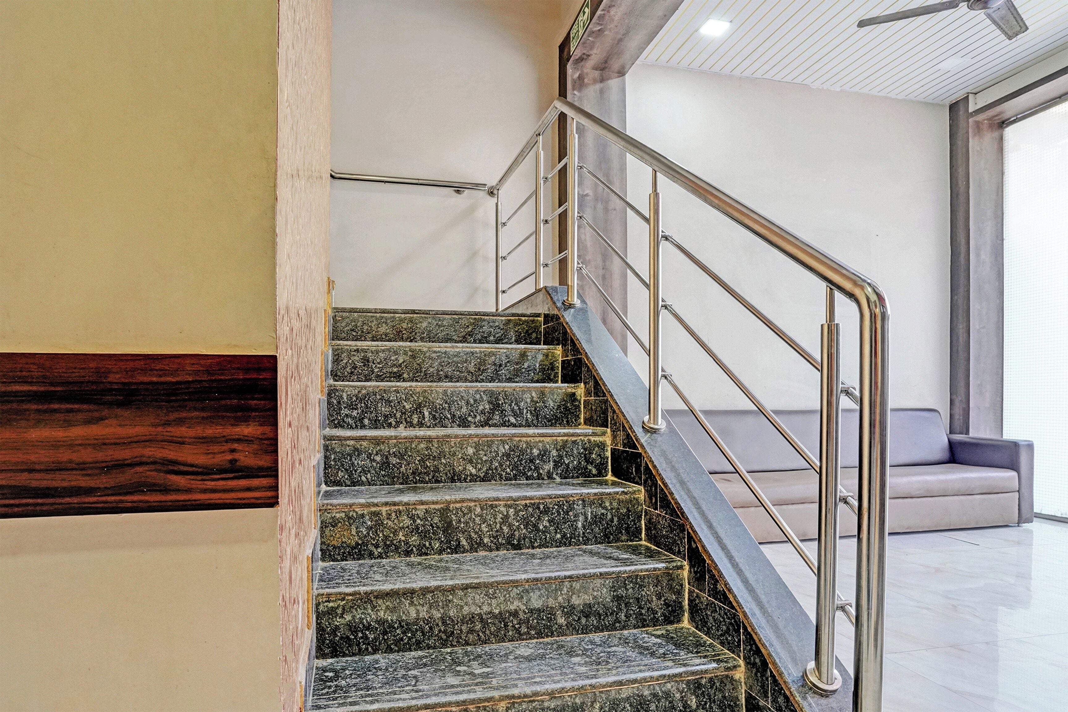 A staircase with metal railings and granite steps.