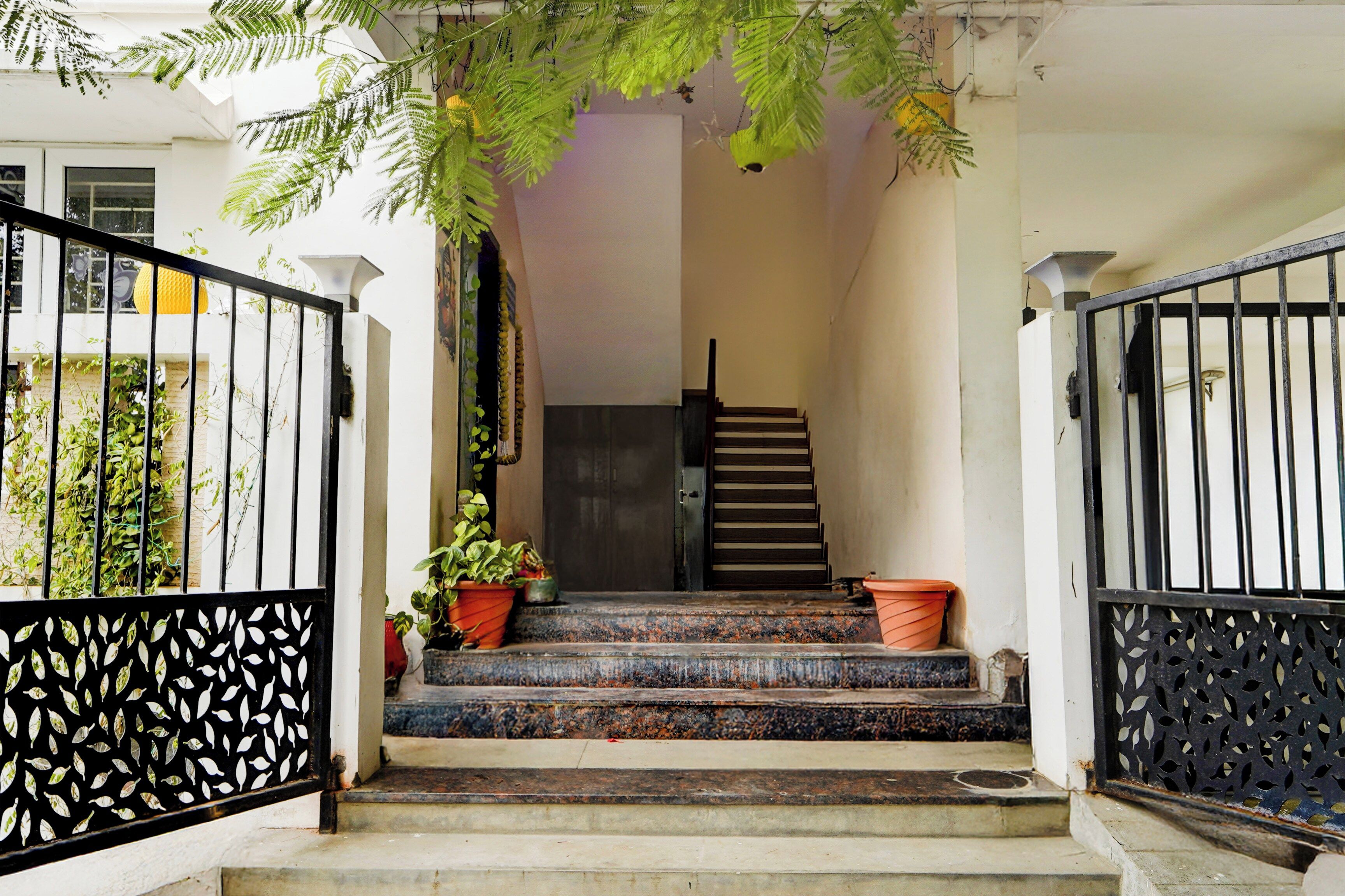 A staircase leading to a door with a metal gate on either side.