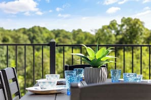 A table set outdoors with a view of a forested landscape. - Private Indoor Pool | Arcade Loft & Hot Tub (Sevierville)