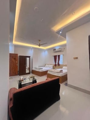A modern bedroom with a bed, a sofa, a desk, and a wardrobe.