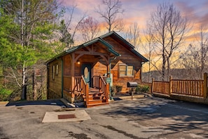 A wooden cabin with a porch, a mailbox, and a street sign. - Sleeps 10, Dog Friendly, Hot Tub, Arcade, Pool Table, 2.5 Mi to Gatlinburg (Gatlinburg)