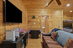 Cozy wood-lined cabin lounge with TV, arcade game, and nearby bunk beds - Sleeps 10, Dog Friendly, Hot Tub, Arcade, Pool Table, 2.5 Mi to Gatlinburg (Gatlinburg)