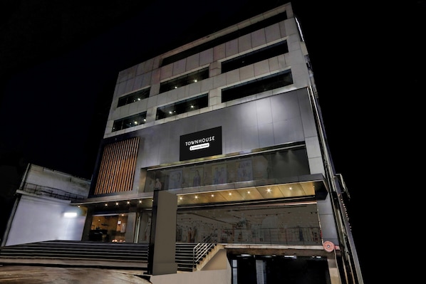 A multi-story building with a prominent sign reading 'TOWNHOUSE Company-Serviced'. - Townhouse Daba Garden Road (Visakhapatnam)