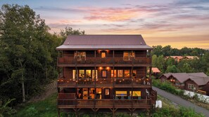 A multi-story wooden cabin with balconies, large windows, and a porch area. - Sleeps 36, Private Indoor Pool, Theater, Arcade, Hot Tub, 11 Mi to Dollywood (Sevierville)