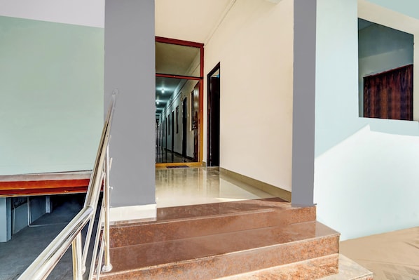 A staircase leading to a landing with a polished marble finish.