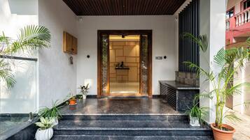 A staircase leading to a room with a wooden ceiling and a view of a balcony.