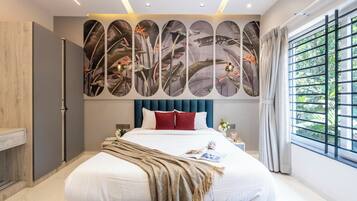 A modern bedroom with a large bed, a decorative wall, and a window with curtains.