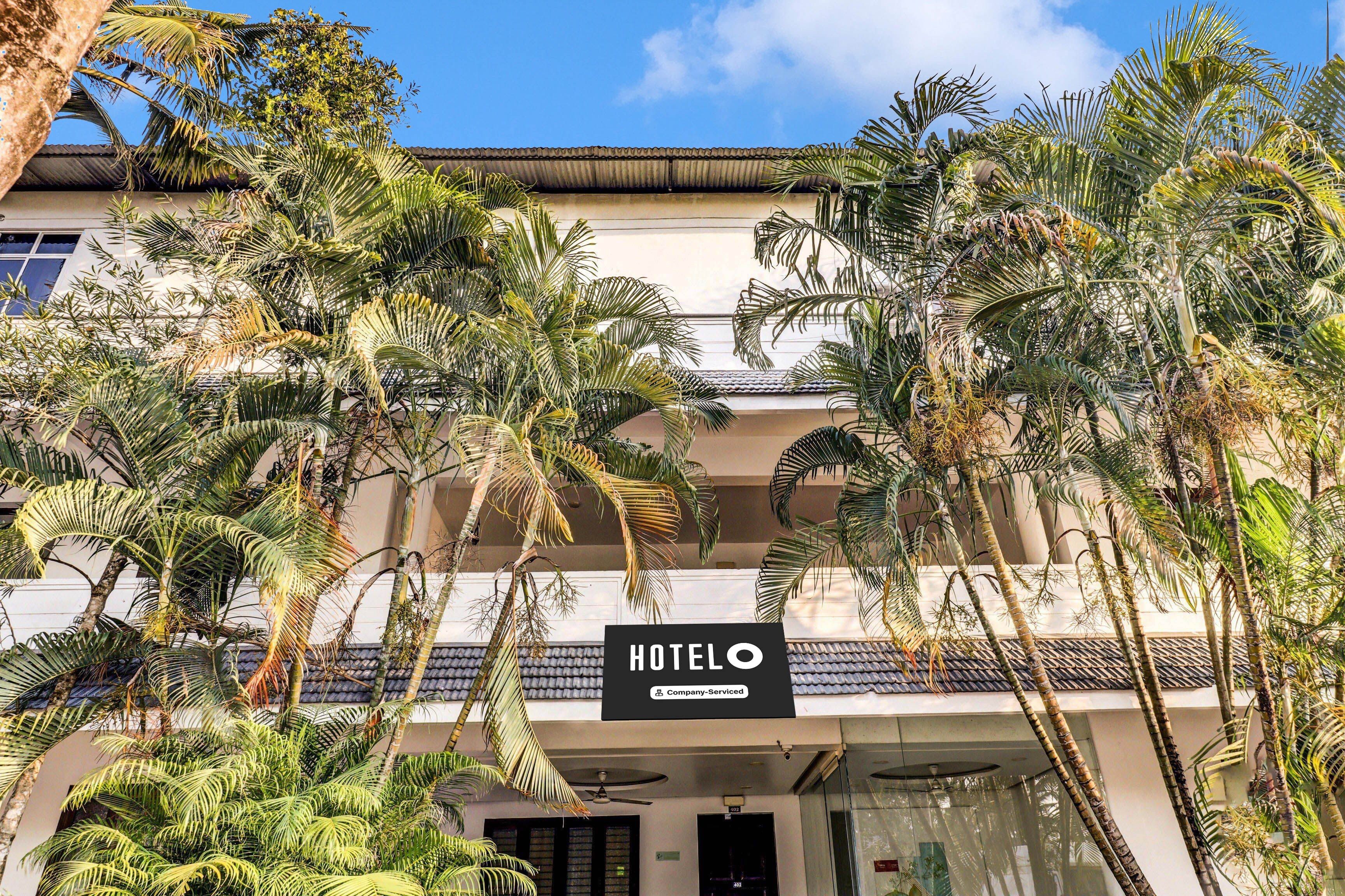 A hotel with a sign reading 'HOTELO' and 'company-serviced' indicating it is a serviced hotel.