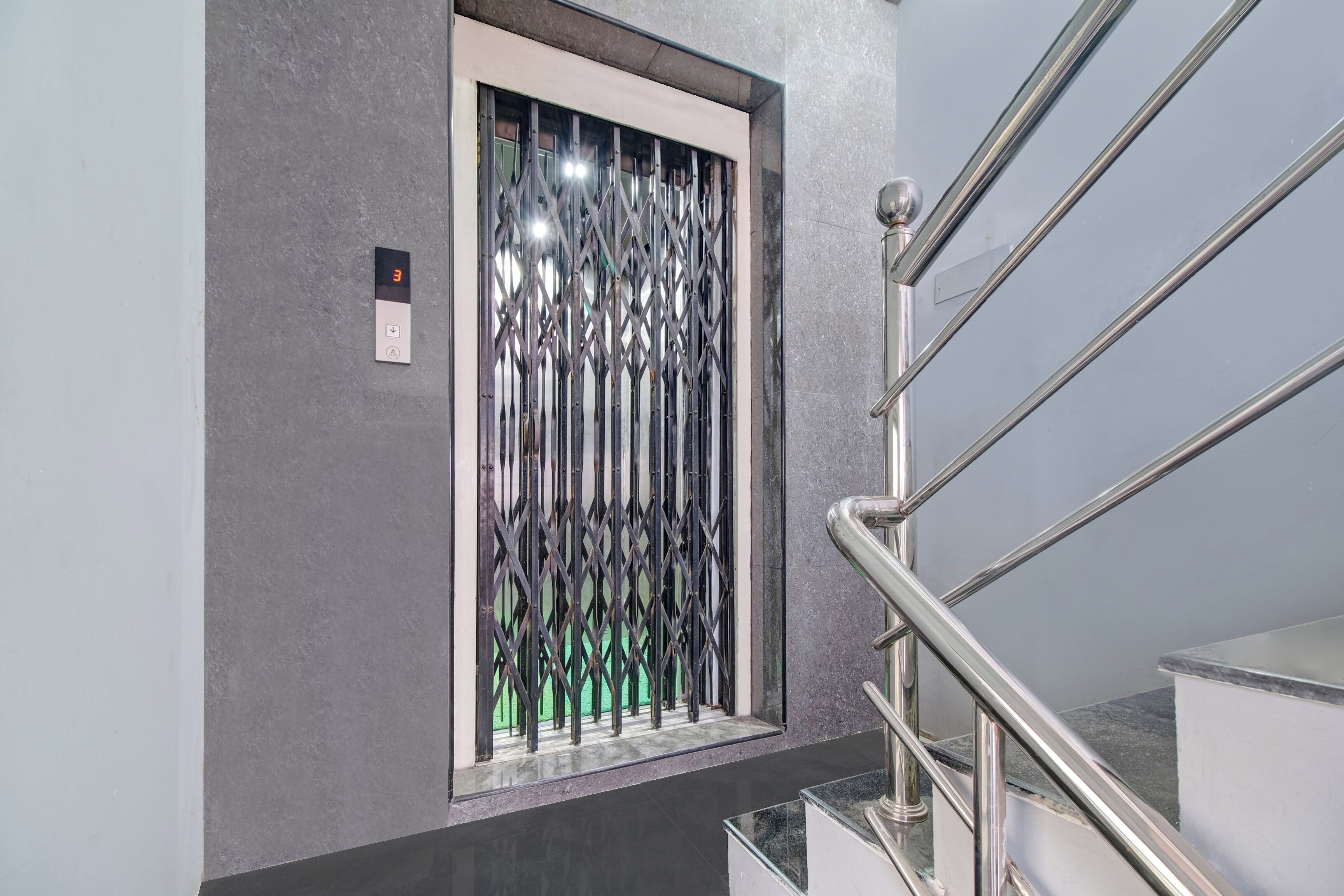 A modern elevator with a metallic, geometric design.