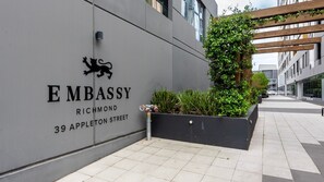 A building with a sign reading 'EMBASSY Richmond 39 Appleton Street' and a lion logo. - Richmond Rhythm | City Living & Lifestyle (Richmond)