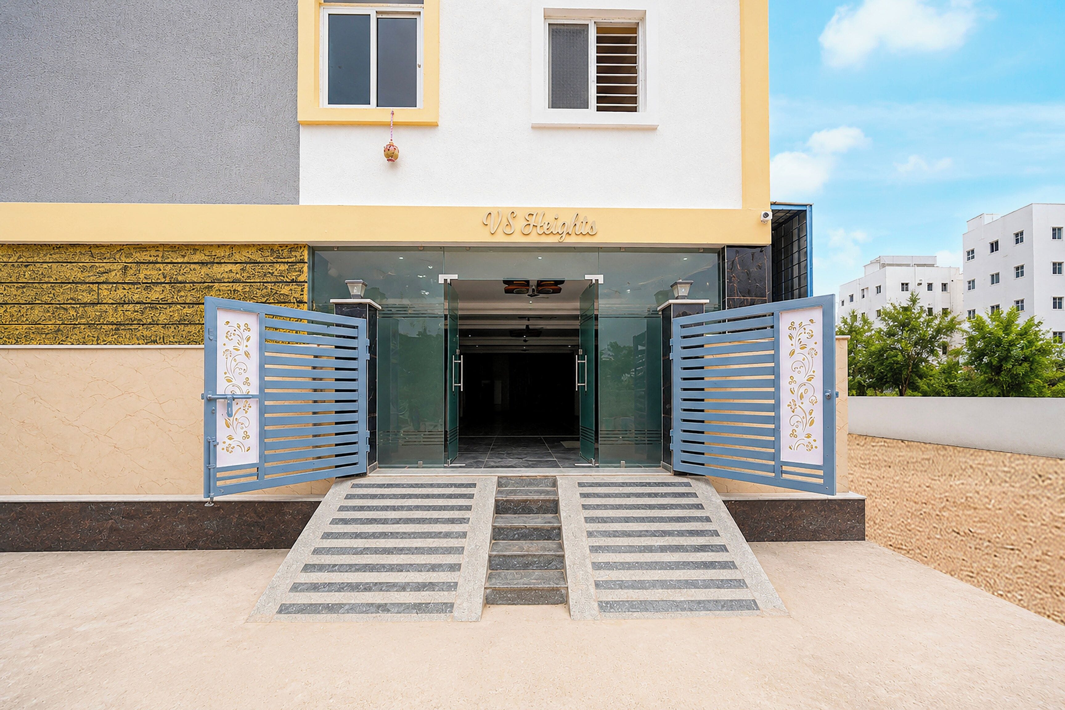 A building entrance with a glass door and a sign reading 'VS Heights'.