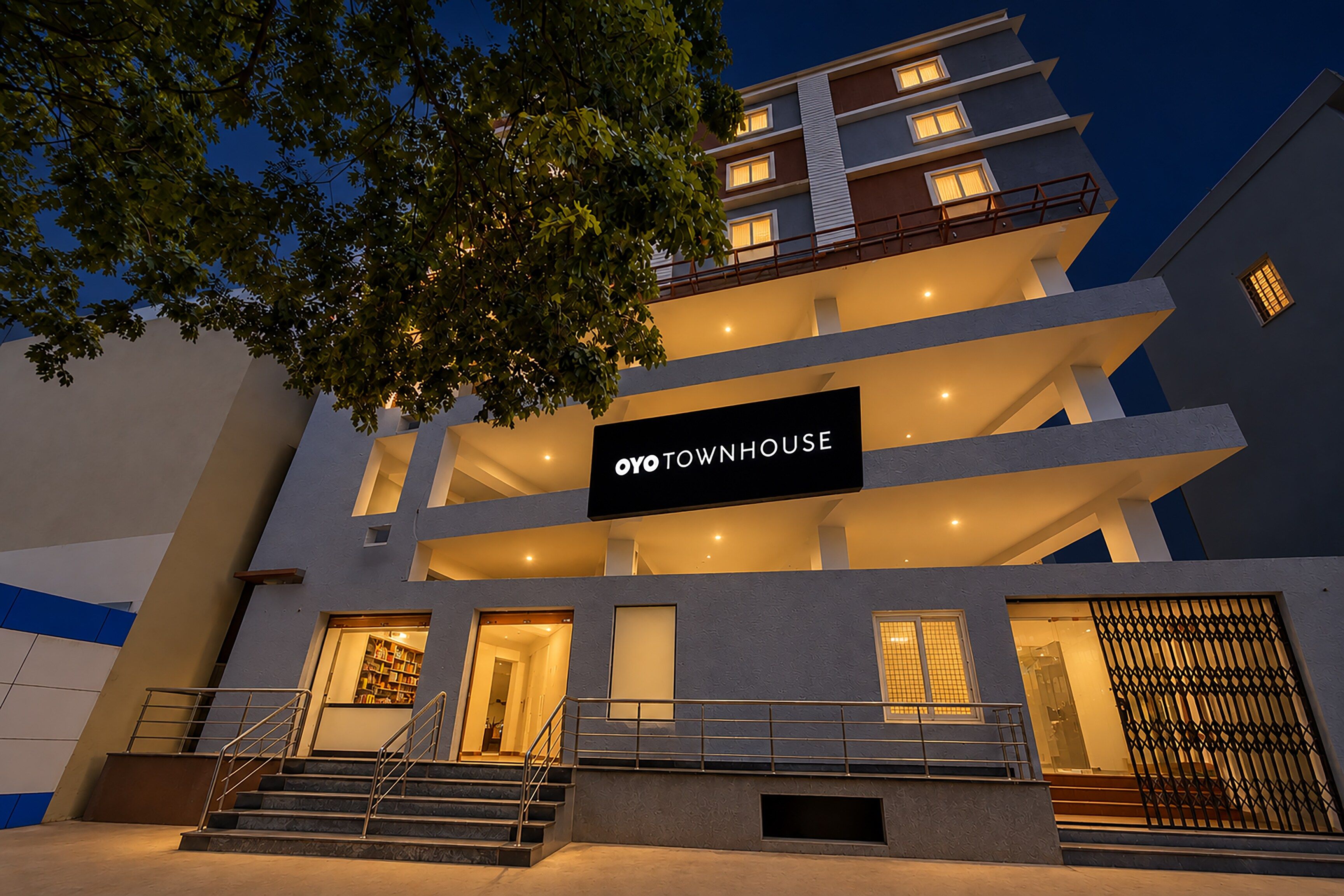A multi-story building with a sign reading 'OYO TOWNHOUSE'.