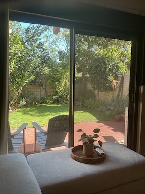 A room with a large window, a wooden bench, and a potted plant on a table. - Whisper quiet South Perth oasis near zoo, river, amenities and public transport (South Perth)
