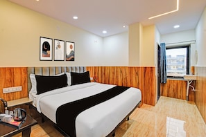 A hotel room with a bed, bedside table, and a window with curtains. - HOTEL O VEDHANSHI HOTEL BIBINAGAR (Hyderabad)