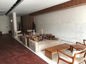 A modern living room with a sofa set, a coffee table, and a dining table with chairs. - New Listing (Salvador)