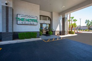 L’extérieur de l’hôtel Sereno se distingue par son panneau d’accueil, son entrée abritée et son espace de stationnement.