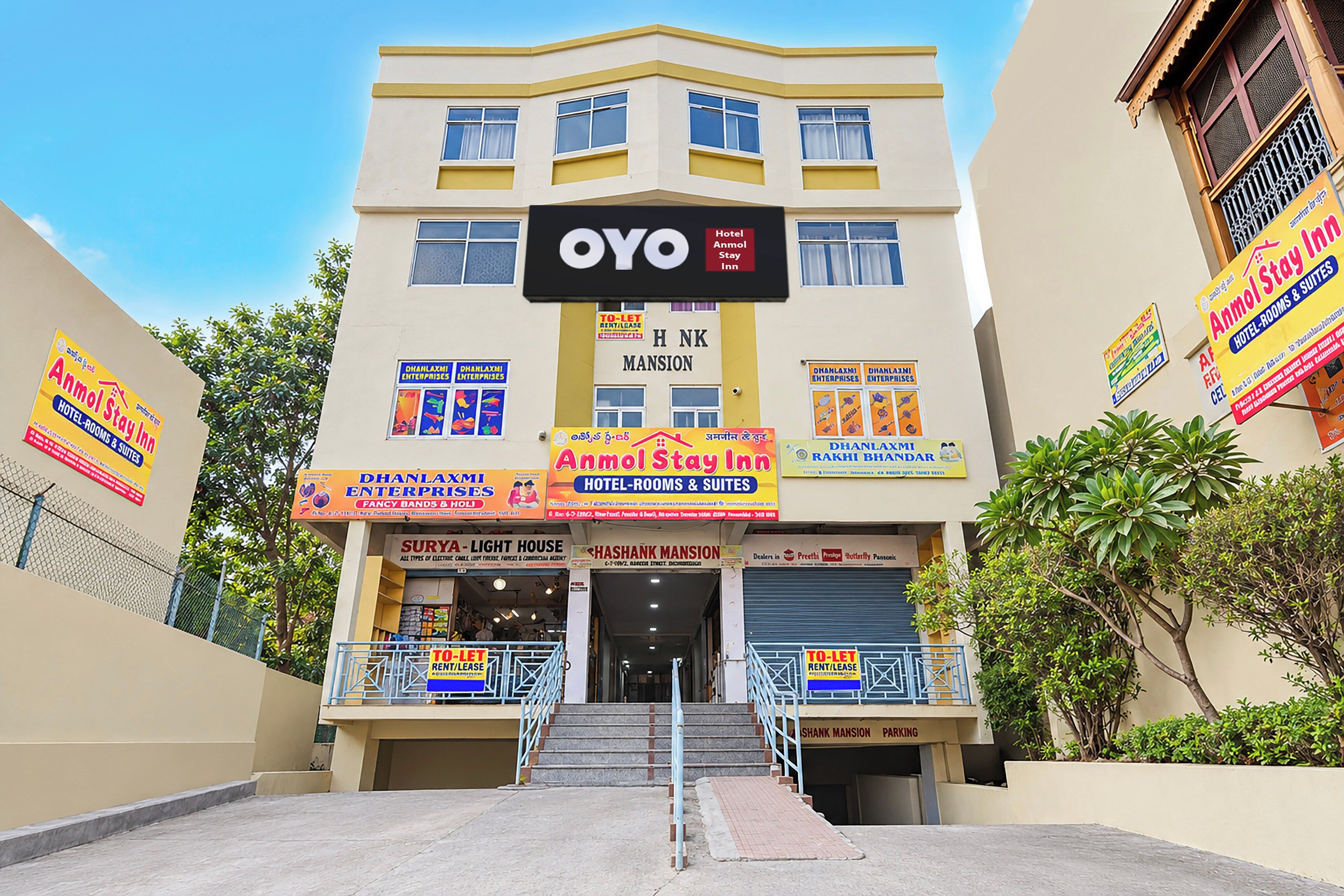 A hotel with multiple signs advertising various services like hotel rooms, suites, and stay-in options.