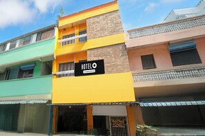 A hotel building with a sign indicating it is company-serviced. - Hotel O Rock Beachview Pondicherry (Puducherry)