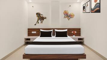 A modern bedroom with a large bed, wooden headboard, and two bedside tables.