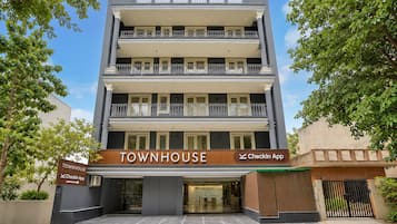 A multi-story townhouse with a 'Townhouse' sign and a 'CheckIn App' sign.