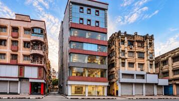 A modern building with multiple floors, large windows, and a mix of architectural styles.