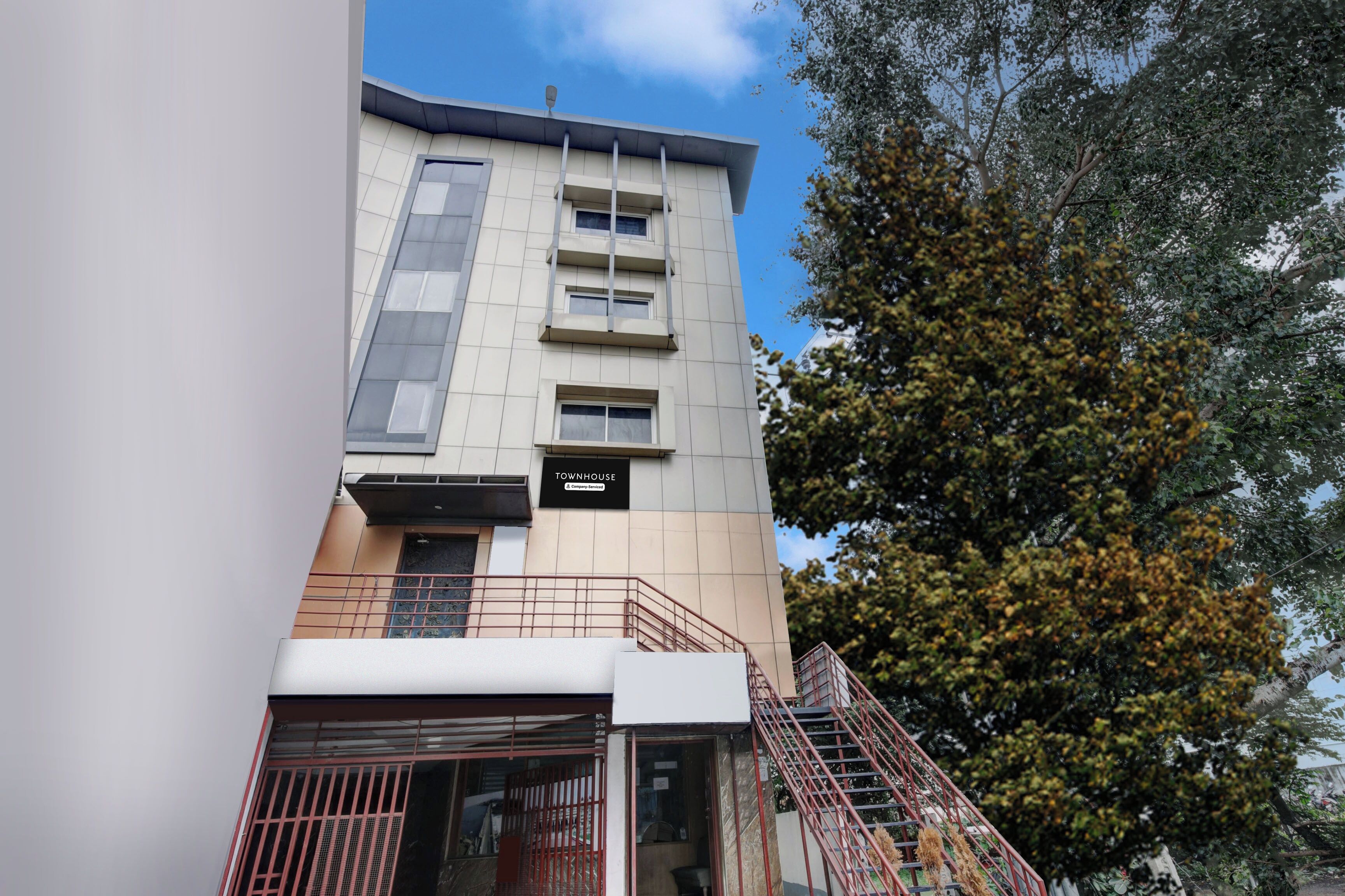 A multi-story building with a sign reading 'TOWNHOUSE'.