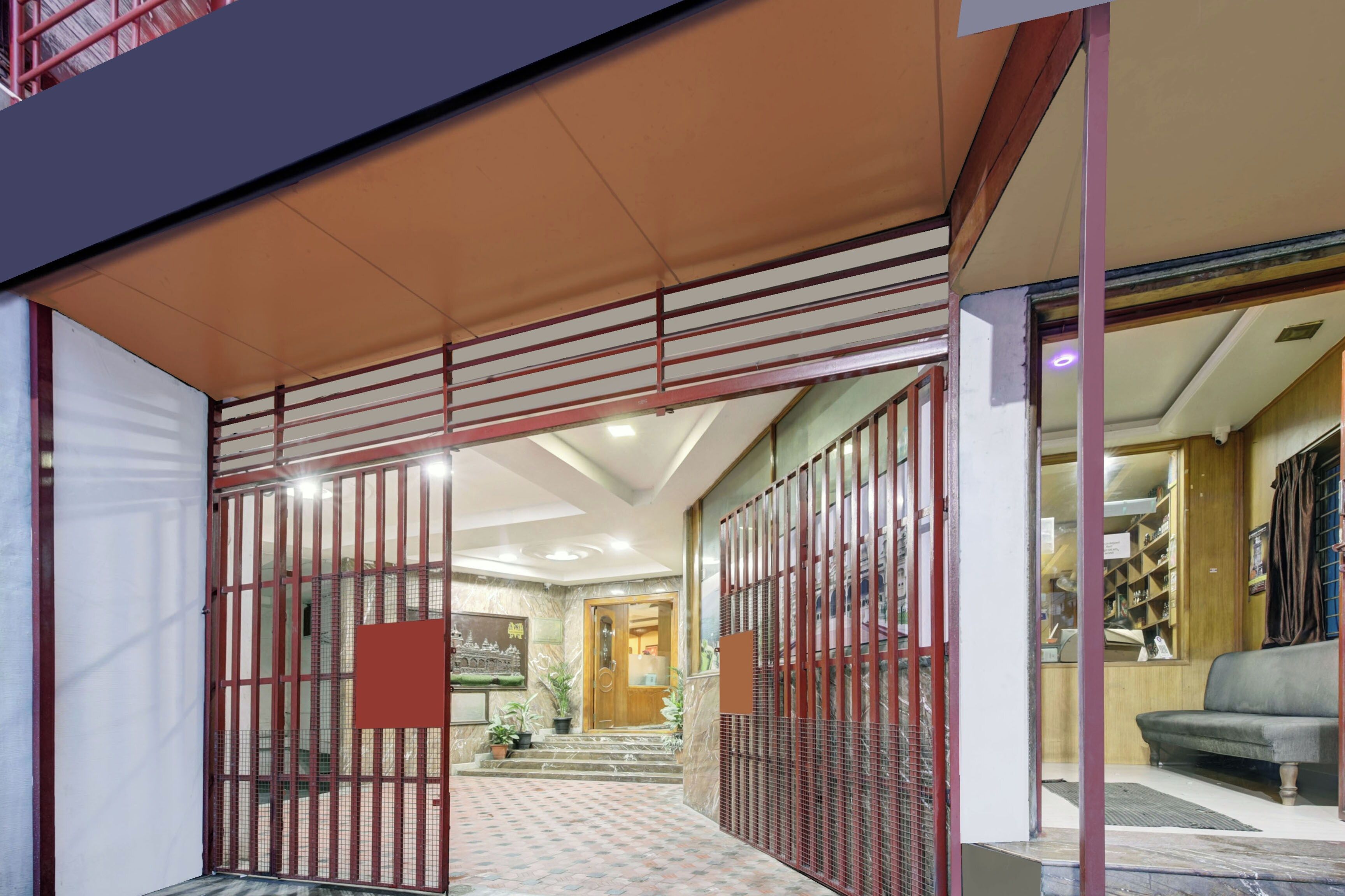 A modern interior with a reception area, a staircase, and a seating area.