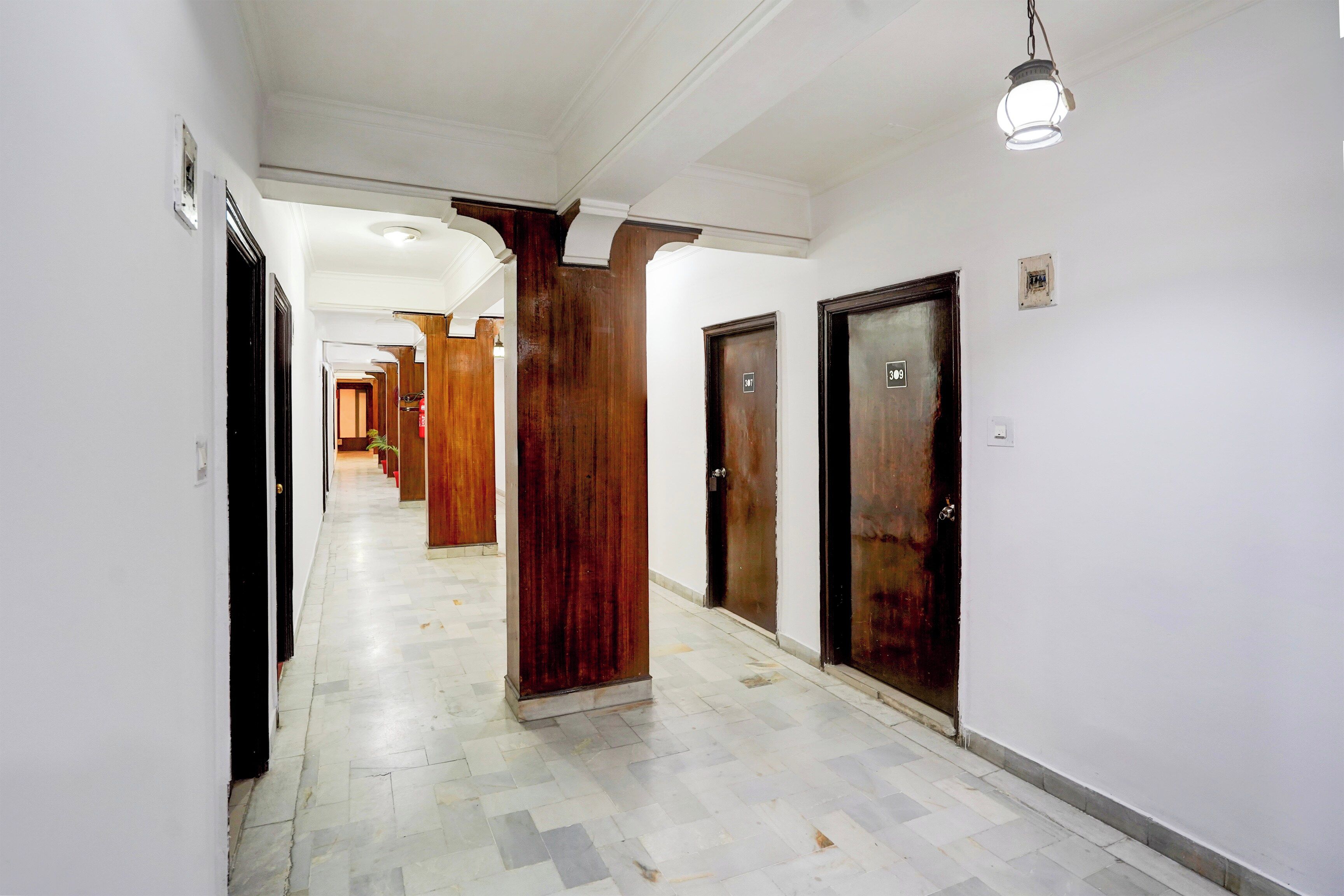 A corridor with doors numbered 307 and 309, leading to rooms.