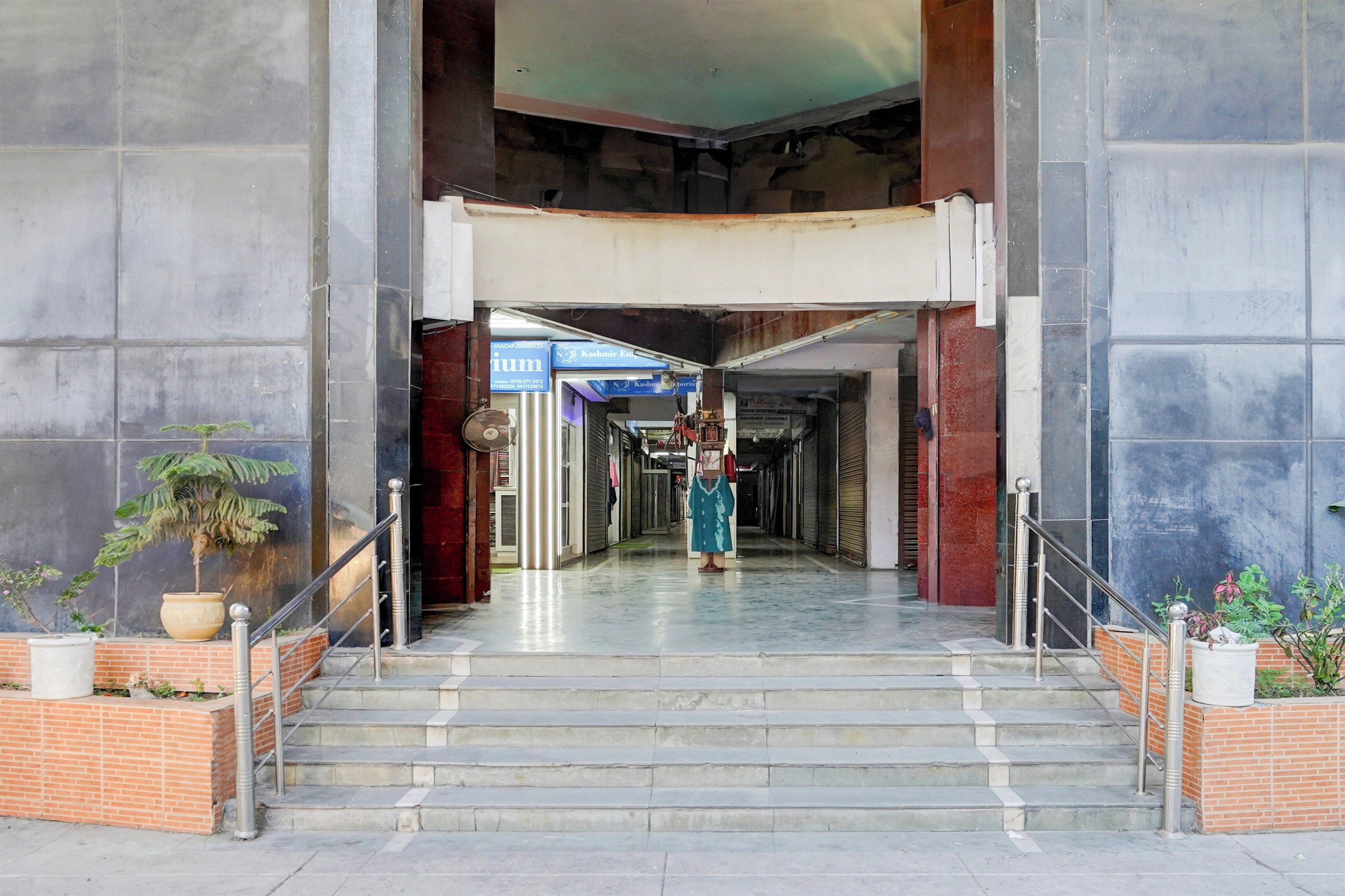 A building entrance with a staircase leading to a covered area.