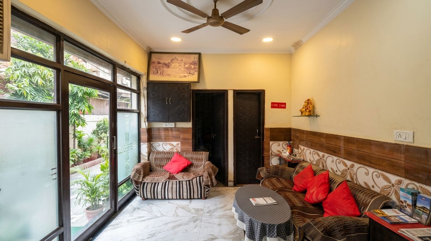 A room with a ceiling fan, a sofa set, a dining table, and a view through large windows.