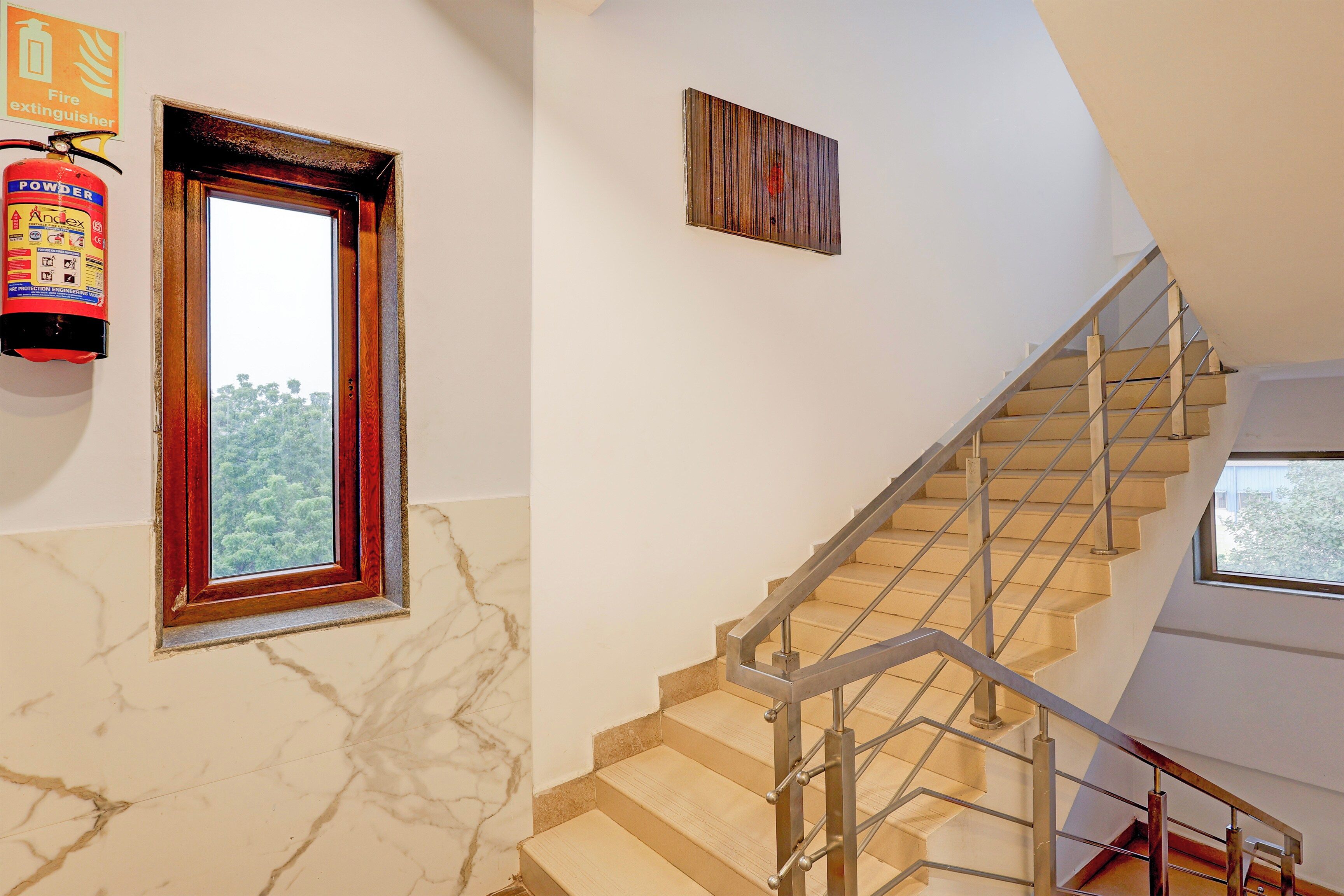 A staircase with a metal railing and a window at the top.