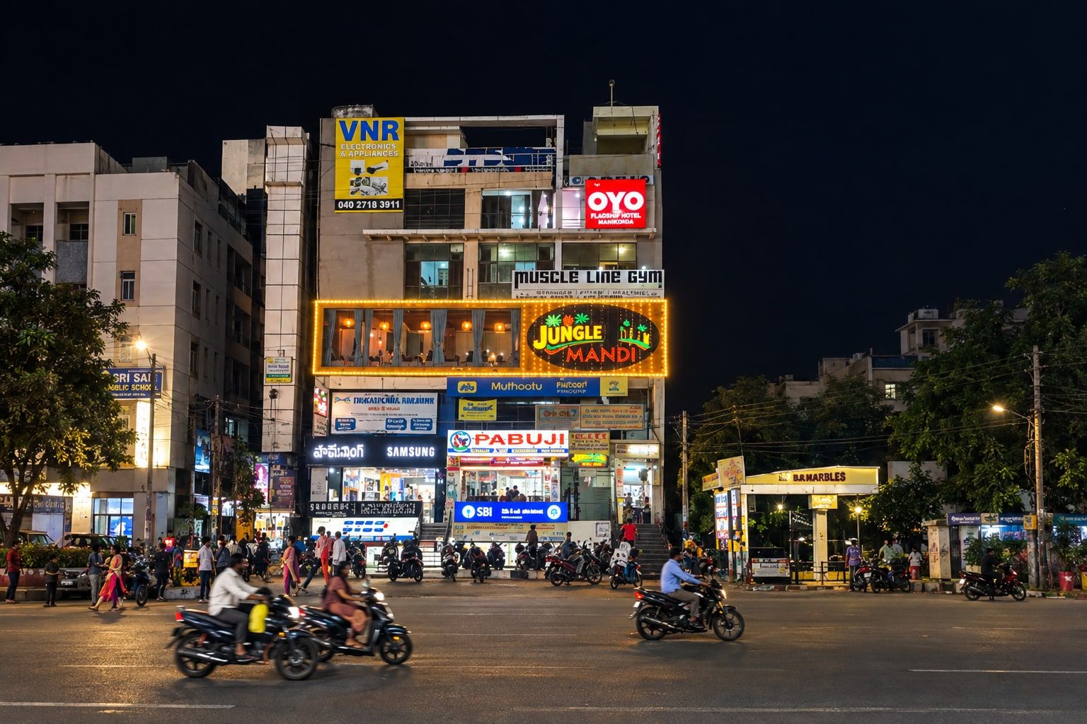 A multi-story building with various commercial establishments including a gym, electronics store, and a hotel.