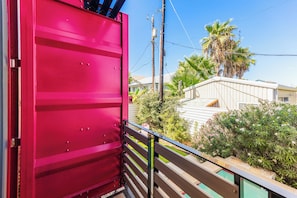A red metal structure, possibly a gate or barrier, with a metal railing in the foreground.