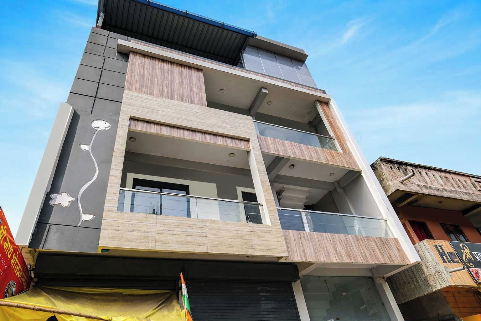 A multi-story building with balconies, large windows, and a flat roof.