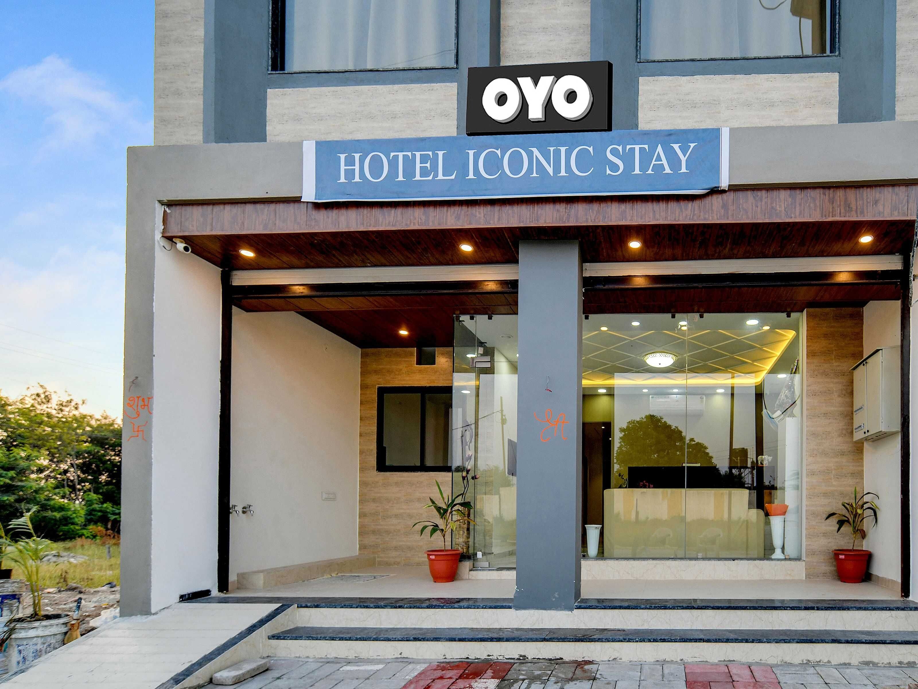 A hotel entrance with a sign reading 'HOTEL ICONIC STAY' and the logo 'OYO'.