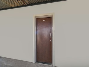 A door with the number 401, a metallic handle, and a small circular lock. - Hotel O BR Greens (Indore)