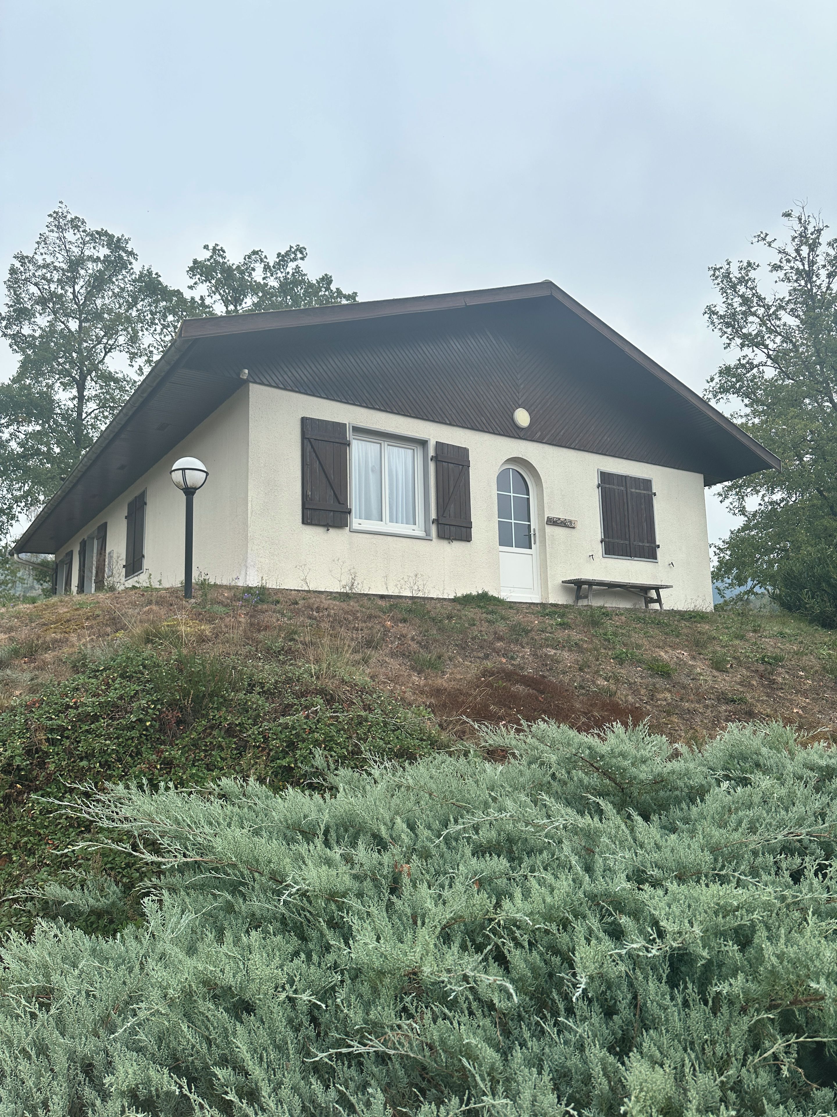 A single-story house with a sloped roof, a front door, and a small porch area.