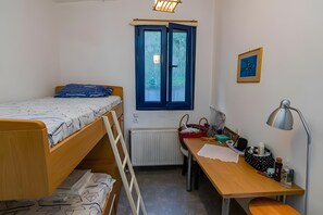 A small, well-lit room with a bunk bed, a desk with a chair, a radiator, and a window with a view of trees. - Holiday Home 'Art Of Luxury' with Sea View, Private Terrace and Air Conditioning (Κάτω Πολυδένδρι)