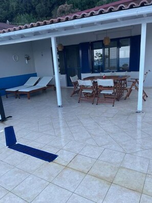 A covered outdoor area with a dining table and chairs, a small pool, and a blue lounge chair. - Holiday Home 'Art Of Luxury' with Sea View, Private Terrace and Air Conditioning (Κάτω Πολυδένδρι)