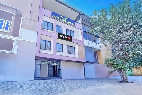 A hotel building with a sign reading 'OYO Hotel The Wings.'
