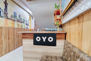 A reception desk with a sign that reads 'OYO' in a hotel lobby. - Hotel O Hotel Krishna's Residency (Indore)