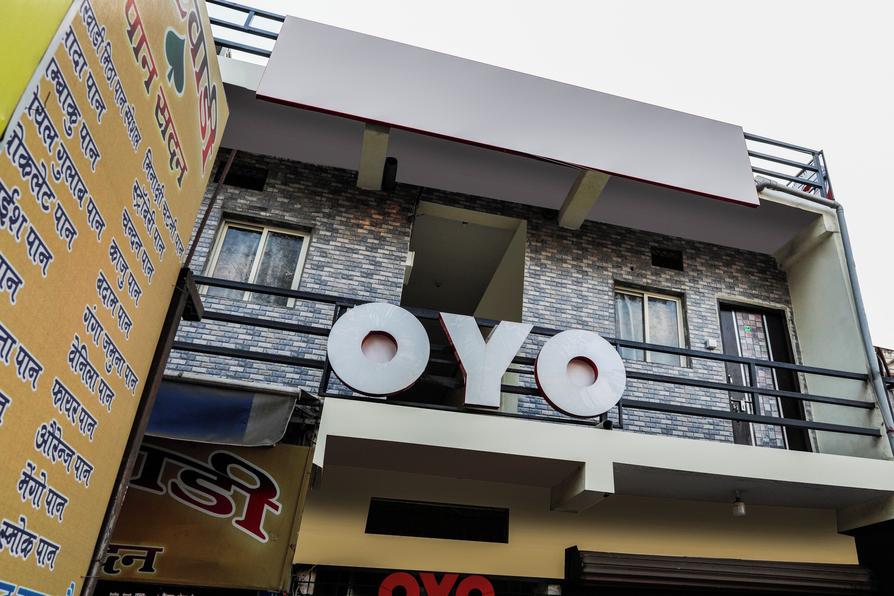 A building with a prominent 'OYO' sign on the facade.