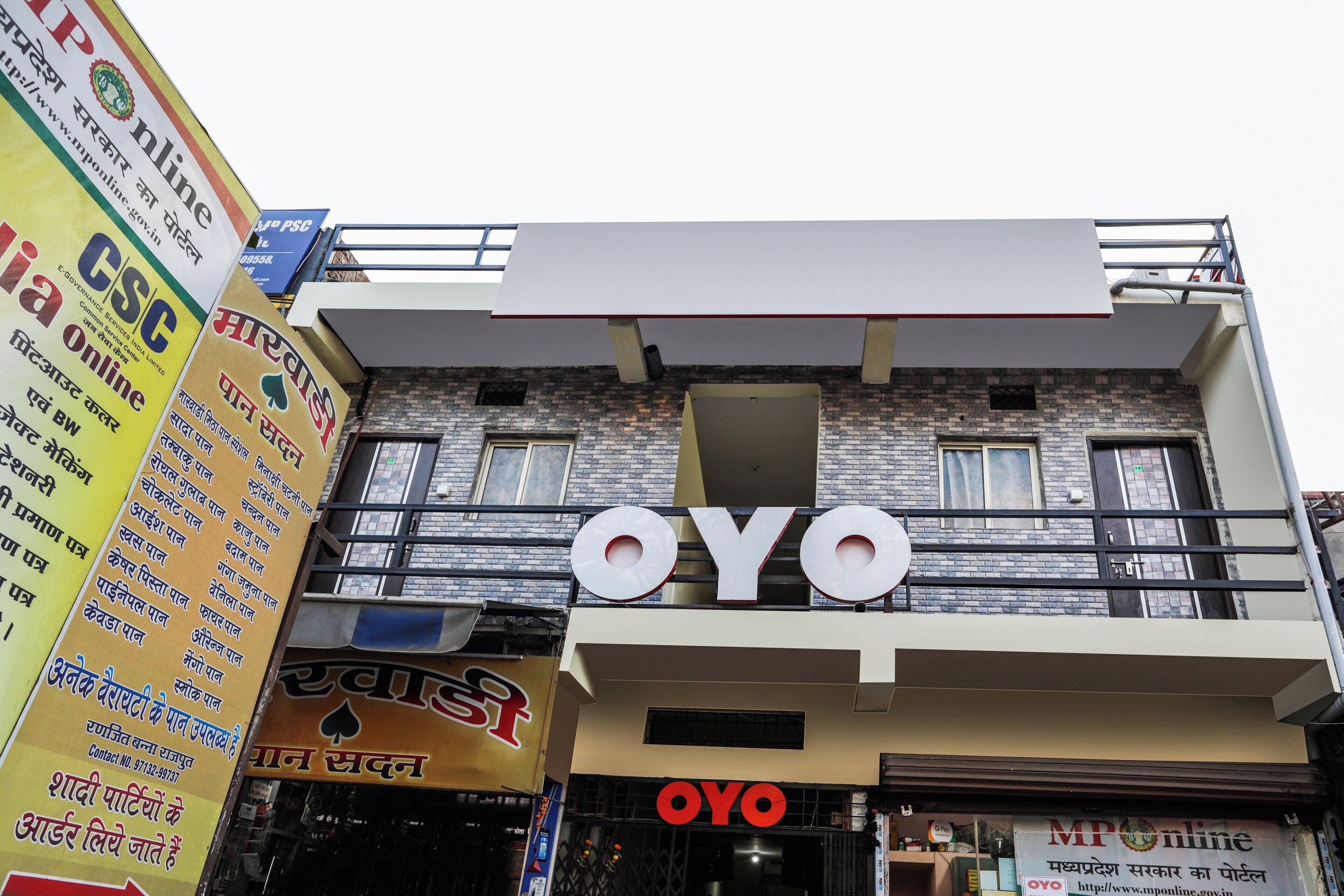 A building with the sign 'OYO' prominently displayed.