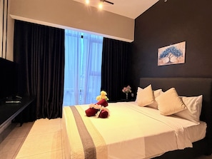 A hotel room with a large bed, a nightstand, a vase with flowers, and a painting on the wall. - Axon Residence KL Pavilion  (Kuala Lumpur)