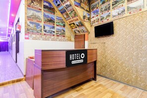 A hotel reception desk with a sign indicating it is company-serviced. - Hotel O by OYO Dariya Railway Station (Chandigarh)