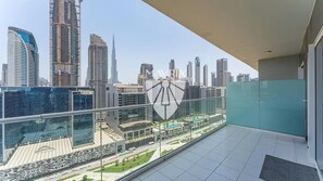 A balcony with a cityscape view, including modern buildings and a bridge. - New Listing (Dubai)