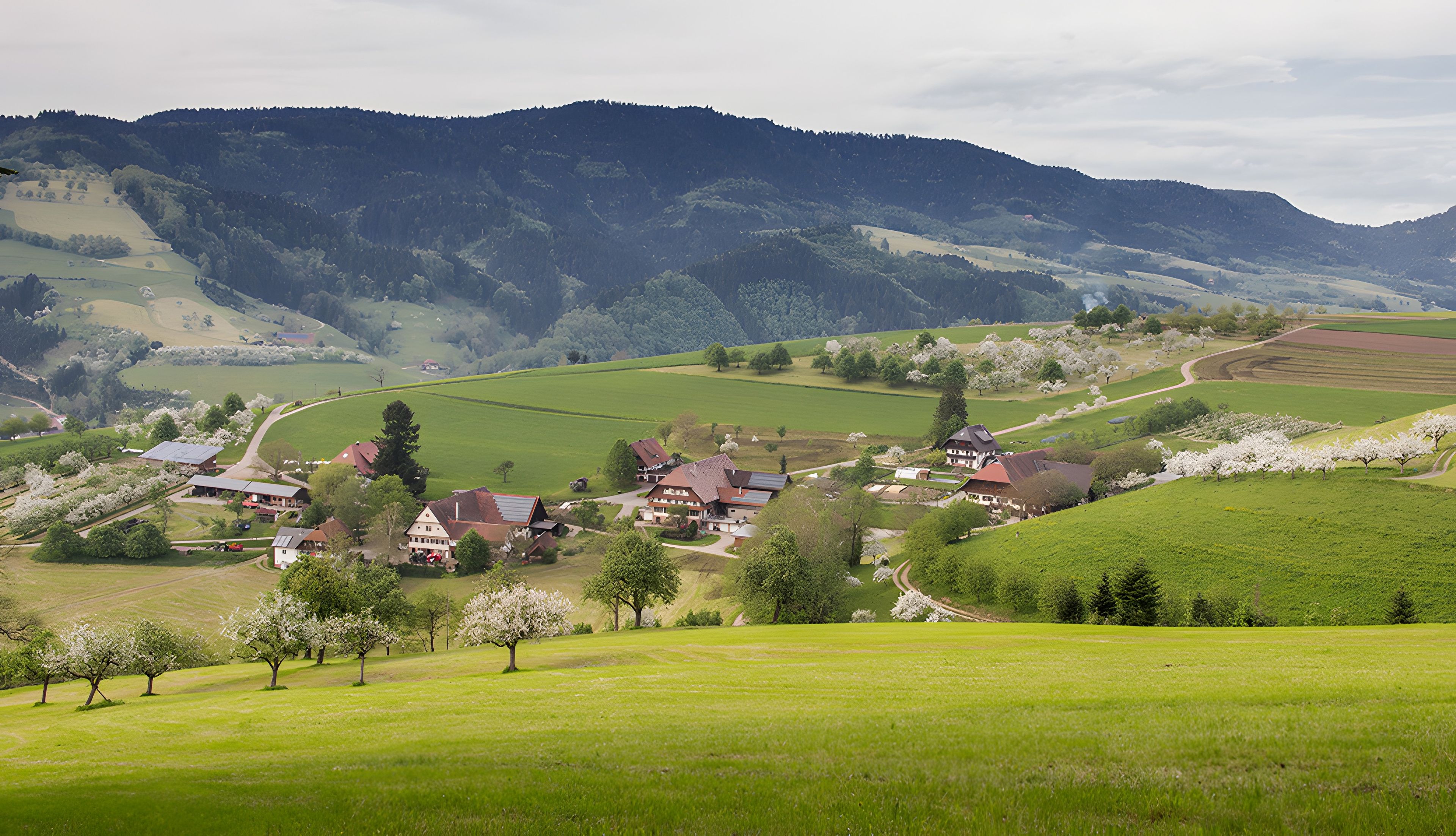 A rural landscape with rolling hills, a village with traditional houses, and a clear sky.