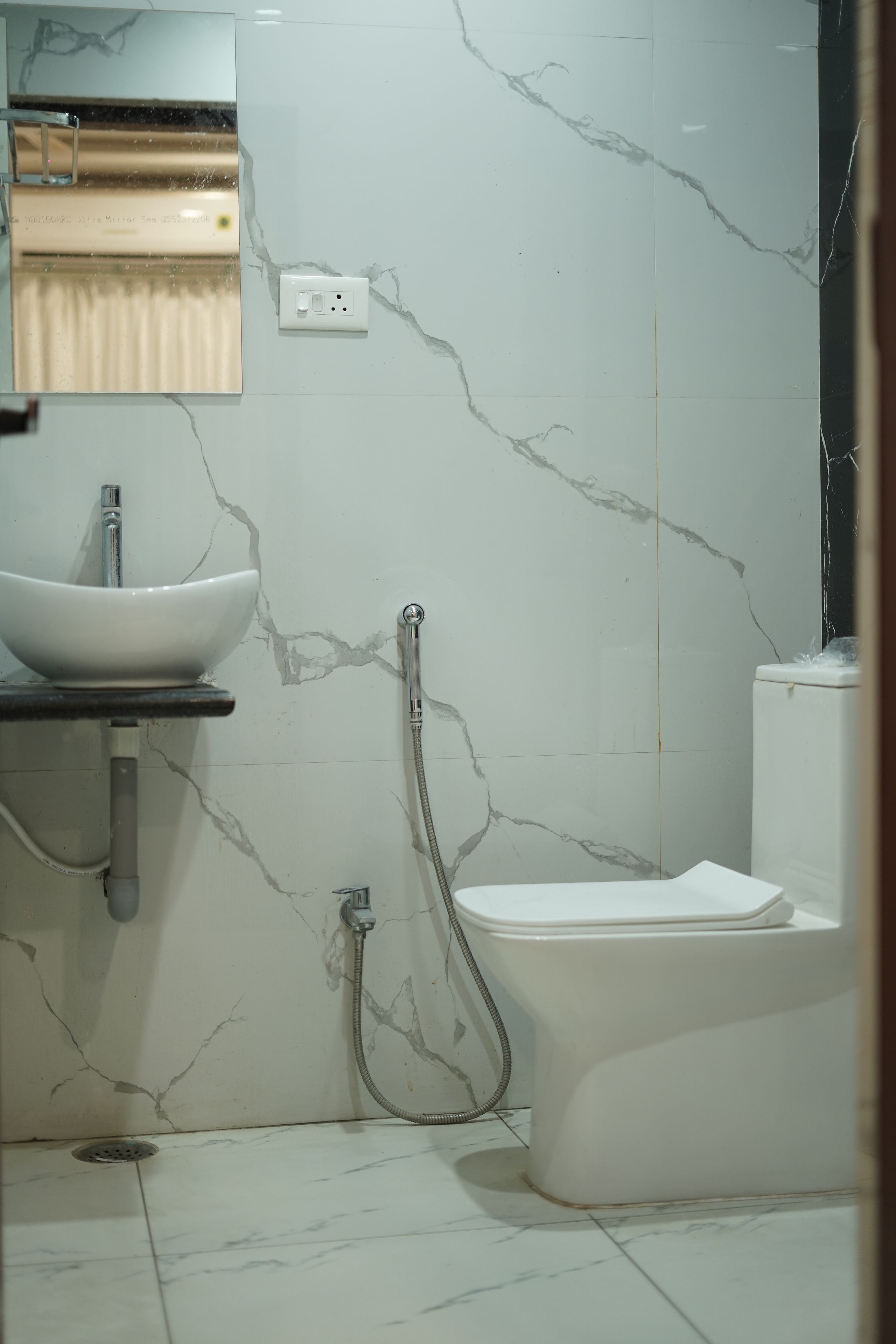 A bathroom with a white sink, a toilet, and a shower.
